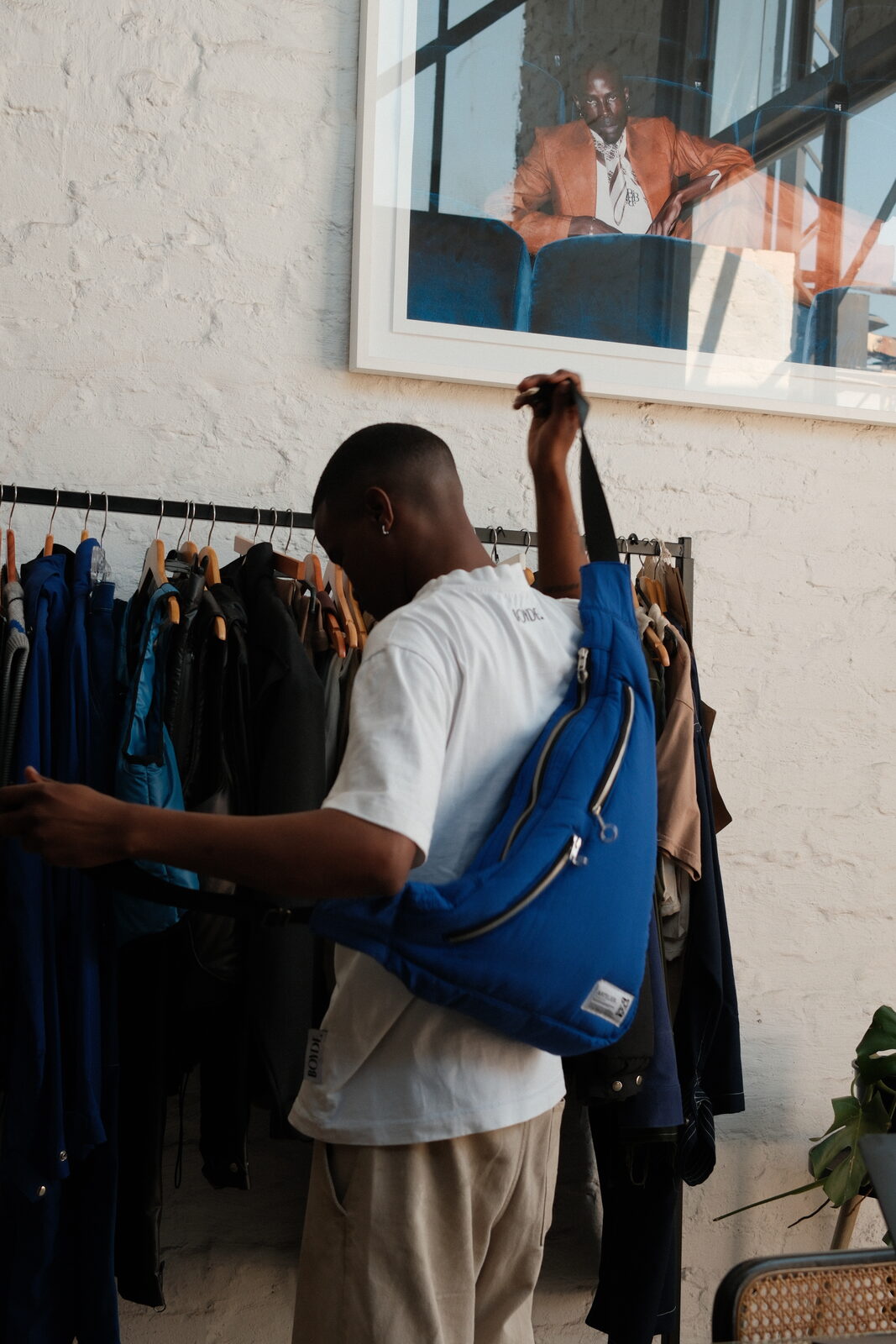 Dineo at the rack with a blue bag
