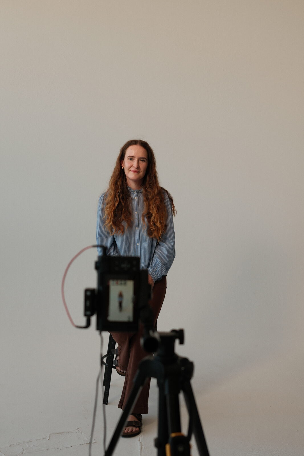 Keziah seated in front of the camera during the interview shoot
